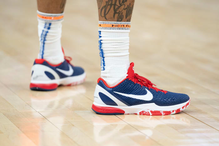 Golden State Warriors guard Gary Payton II's red, white, and blue Nike shoes.